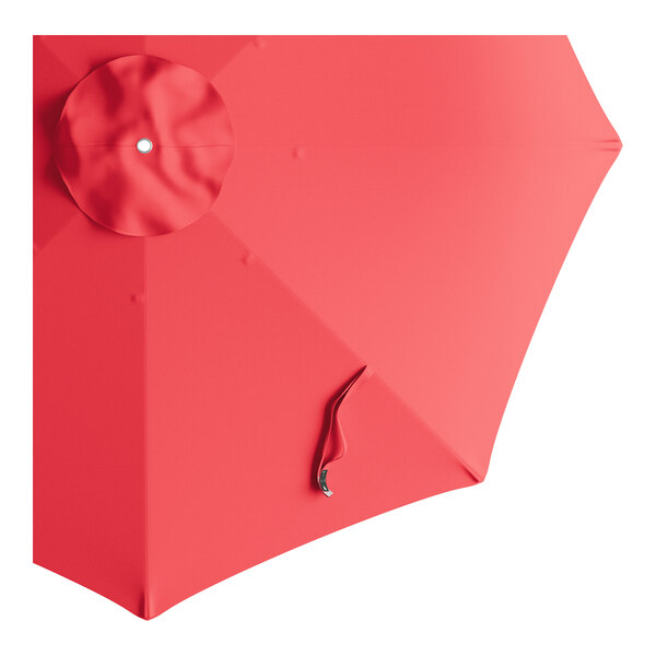 A red umbrella canopy for a Lancaster Table & Seating Bamboo Pulley Lift Umbrella with a white circle.