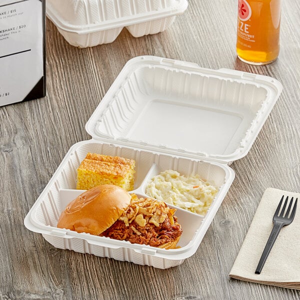 A white Choice 3-compartment take-out container with food and a black plastic fork inside.