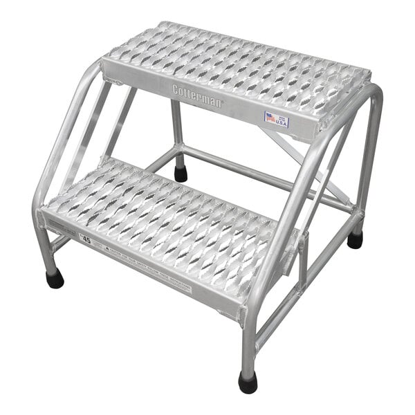 A silver metal Cotterman step ladder with black wheels.