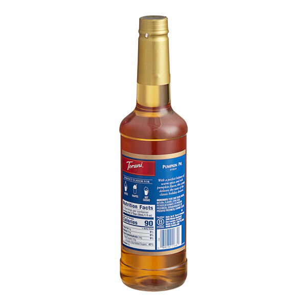 A close up of a Torani Pumpkin Pie flavoring syrup plastic bottle with a blue label.