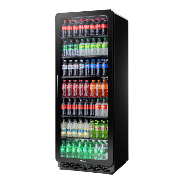 A black True refrigerator with bottles of soda inside.