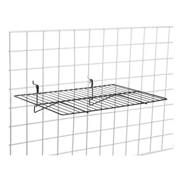 A black wire shelf on a white grid.