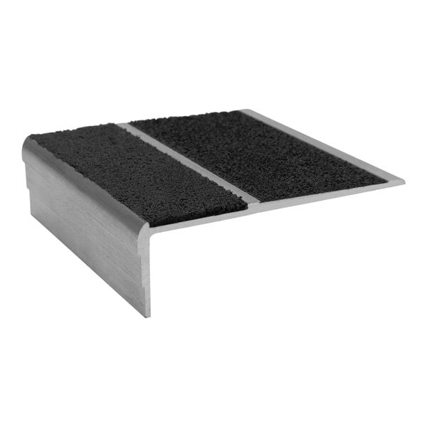 A close-up of a Wooster black and silver metal stair tread with black and silver grit surface.