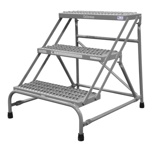 A grey metal Cotterman 3-step steel step ladder.