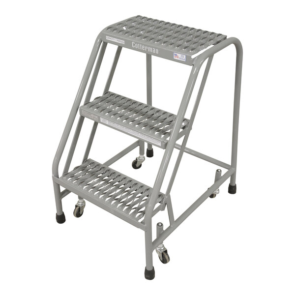 A gray powder-coated steel Cotterman rolling ladder with three steps and wheels.