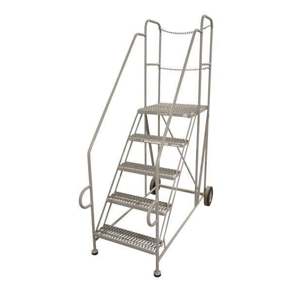 A close-up of a gray powder-coated steel Cotterman trailer access platform ladder with wheels.