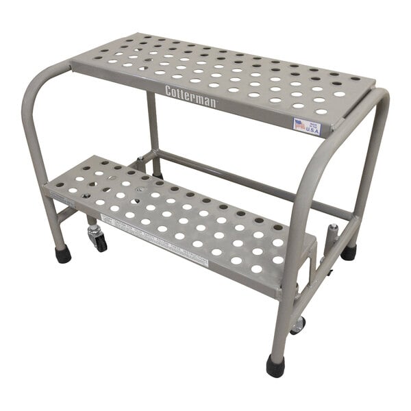 A gray powder-coated steel Cotterman rolling ladder with perforated steps.