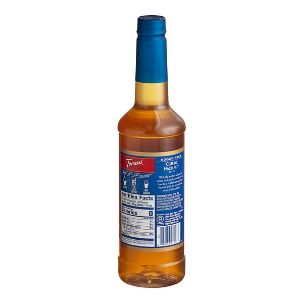 A plastic bottle of Torani Sugar-Free Classic Hazelnut Flavoring Syrup with a blue label.