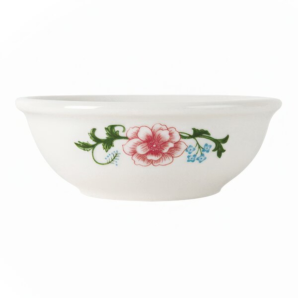 A white Tuxton china bowl with a flower design.