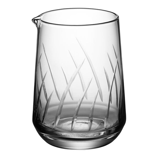 An Acopa clear glass stirring/mixing pitcher with a design on it.
