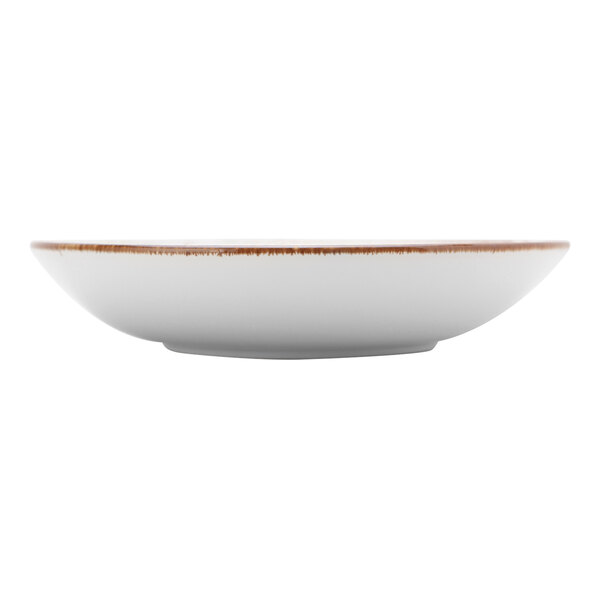A white Tuxton pasta bowl with a brown rim.