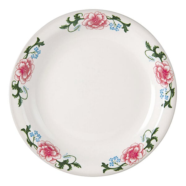 A white Tuxton Western Rose China plate with pink flowers and green leaves.
