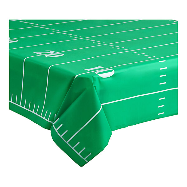 A green football field tablecloth with white lines on it.