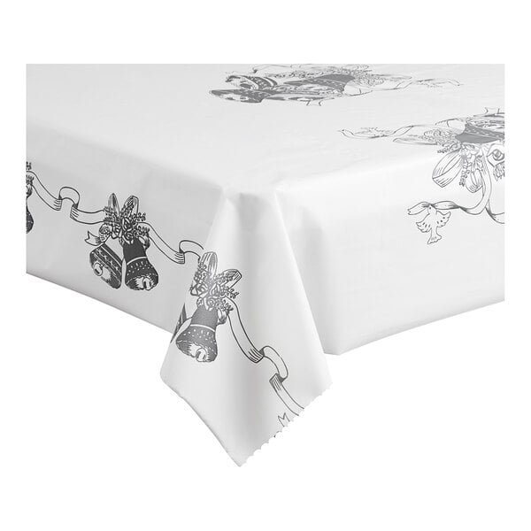 A white tablecloth with black and white wedding bells on it.