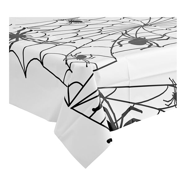 A Table Mate white table cover with black spider webs on a table.