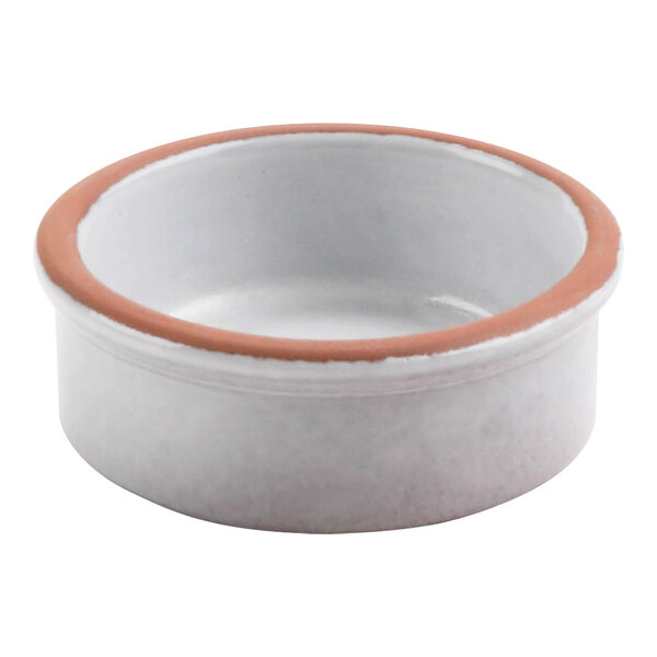 A white terracotta casserole dish with a brown rim.