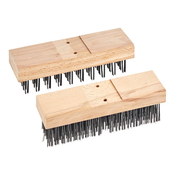 A wooden brush with two black bristles on it.