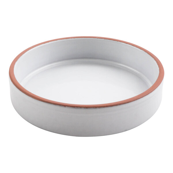 A white terracotta casserole dish with a red rim.