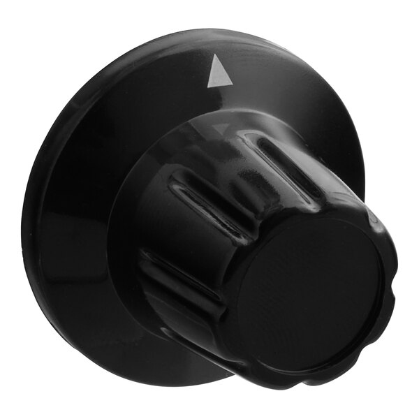 A close up of a black plastic knob with a white arrow.