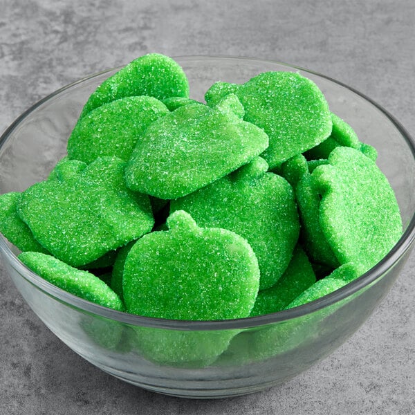 A bowl of Vidal Sour Gummy Green Apples on a table.