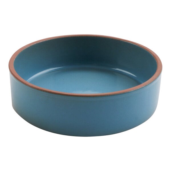 A blue terracotta casserole dish with a brown rim.