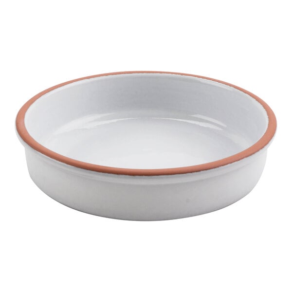 A white terracotta casserole dish with a brown rim.