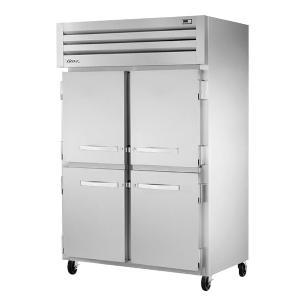 A white True reach-in refrigerator with four half doors.