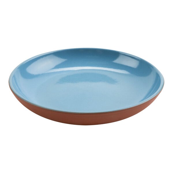 A blue terracotta bowl with a brown rim.