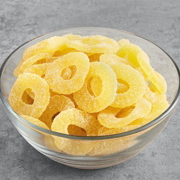 A bowl filled with yellow Vidal Gummy Pineapple Rings.