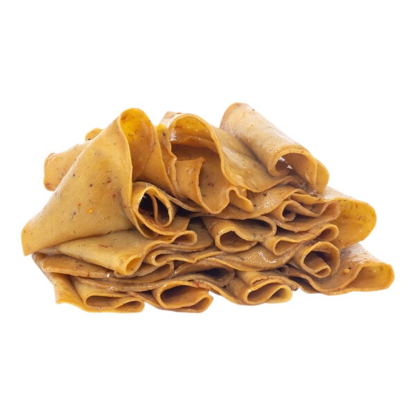 A stack of folded plant-based vegan seitan deli slices.