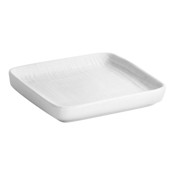 A white square soap dish with a white rim.