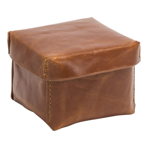 A brown square faux leather box with a lid and stitched edge.