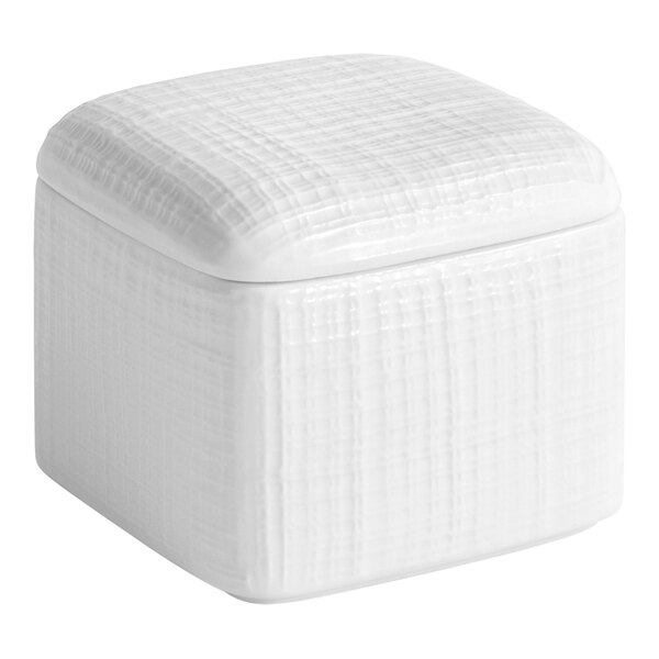 A white square porcelain storage jar with a lid.