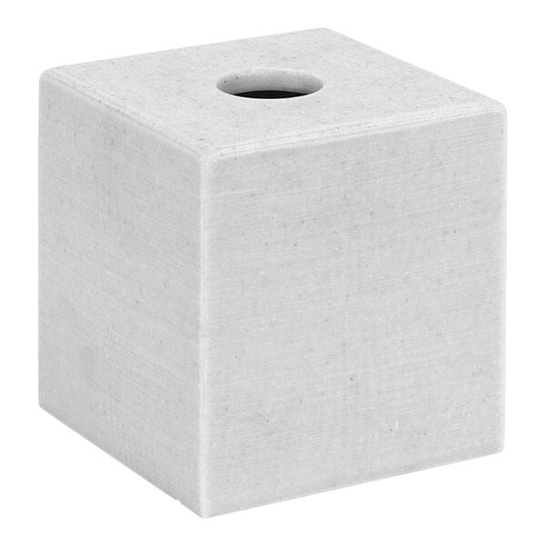 A white square cement tissue box cover with a hole in the top.