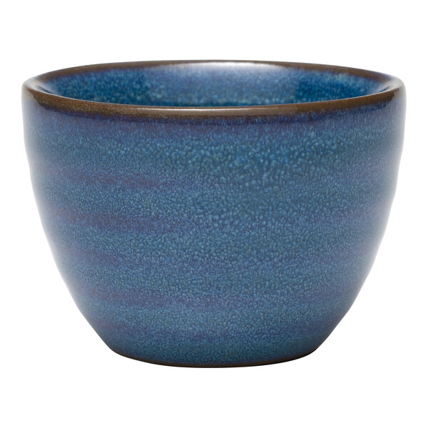 A blue terracotta dip dish with a brown rim.