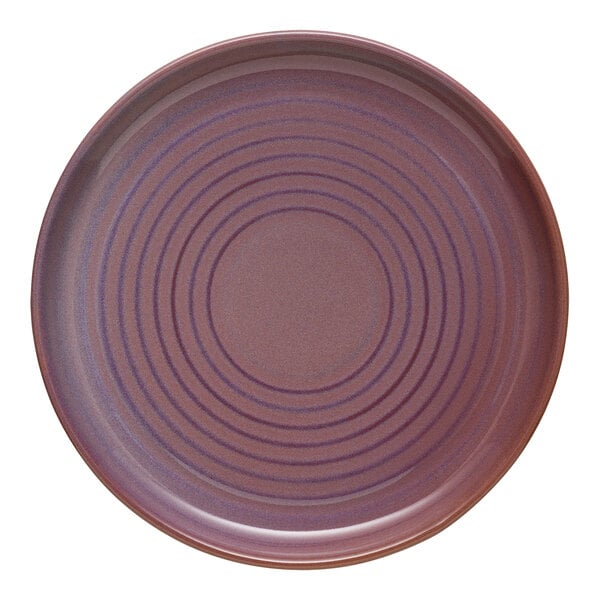 A Libbey mauve terracotta stoneware plate with a circular spiral pattern.