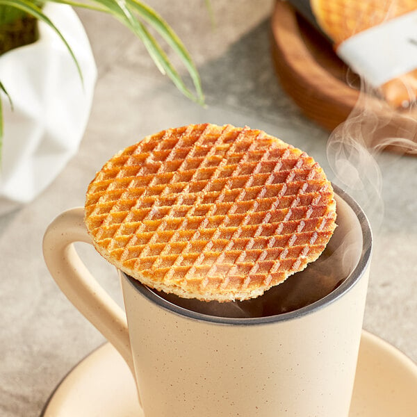 An Individually wrapped Vafels vegan caramel stroopwafel on a white plate.