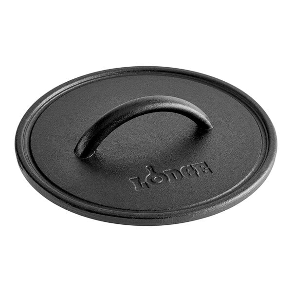 A black cast iron lid with a handle.