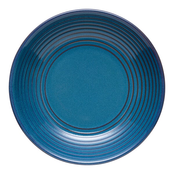 A close up of a blue Libbey terracotta coupe bowl with stripes.