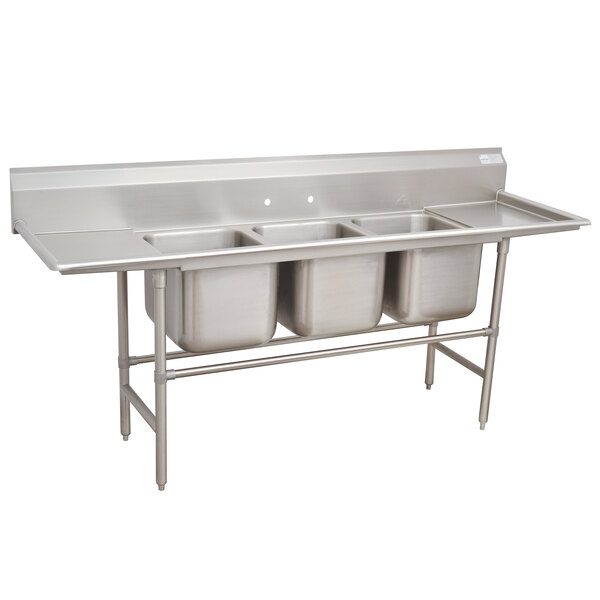 An Advance Tabco stainless steel three compartment sink with two drainboards.