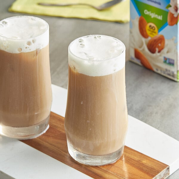 Two glasses of Almond Breeze almond milk on a tray.