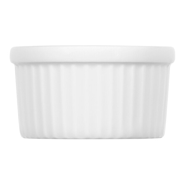 A close-up of a white round fluted porcelain ramekin.