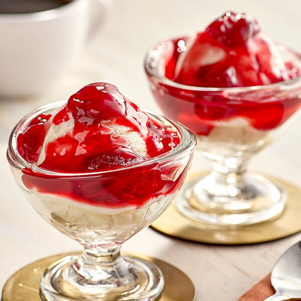 Two desserts in glass dishes with Creamery Ave. Premium Strawberry Dessert on top.