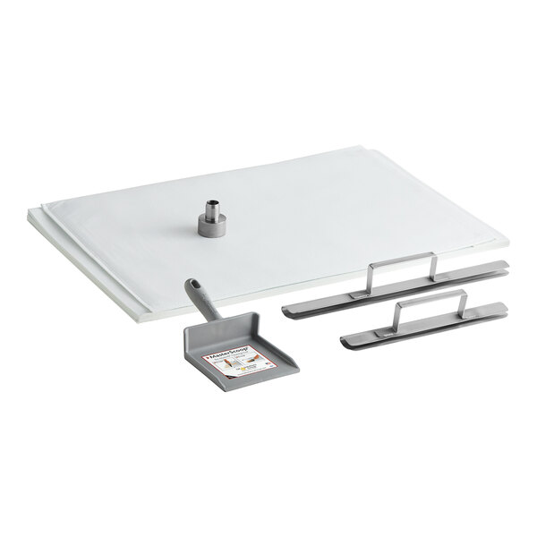 A white rectangular tray with a metal handle and two metal tools.