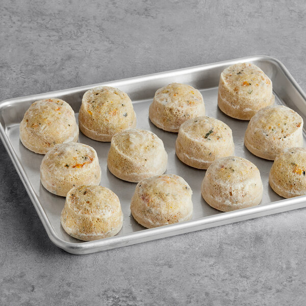 A round white object with brown spots, filled with food.