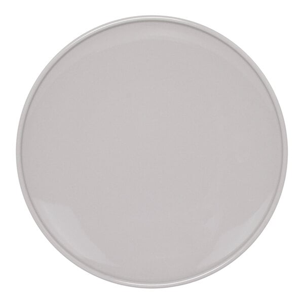 A close-up of a Front of the House Bevel round porcelain plate with a white border.