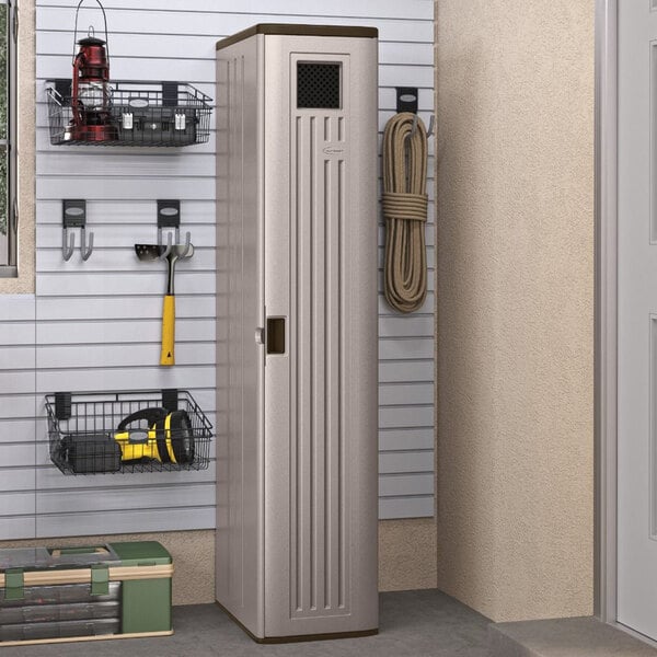 A green Suncast storage cabinet with black shelves holding tools.