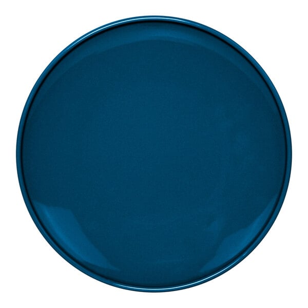 A close-up of a blue Front of the House Bevel porcelain plate with a white border.