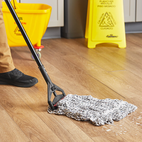 A person mopping the floor with a Lavex blue and white mop.