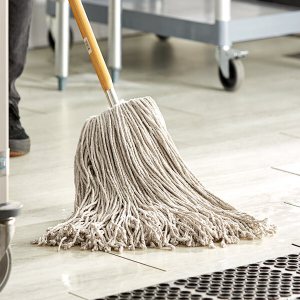 A natural cotton Cut-End Mop head on a floor.